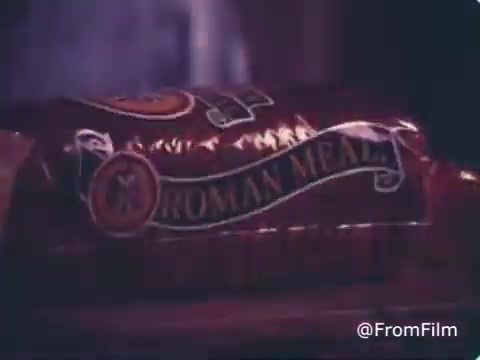 The 16mm still from the 1970s Roman Meal Bread commercial features a close-up of a loaf of Roman Meal bread, prominently displaying its distinctive packaging. The brand emphasizes its whole-grain focus, appealing to health-conscious consumers of the era. The imagery reflects a nostalgic, wholesome approach typical of commercials from that period, highlighting the product's quality and heritage.