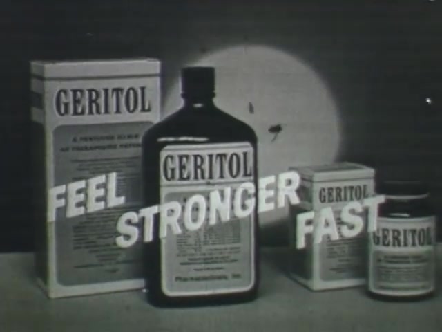 The still features a vintage Geritol commercial from the 1950s, prominently displaying various Geritol products: a large bottle, boxes, and smaller containers. The bold, compelling text reads 'FEEL STRONGER FAST,' emphasizing the product's benefits. The monochrome aesthetic is typical of the era, enhancing the nostalgic feel of mid-20th-century advertising. The arrangement suggests a focus on health and vitality, common themes in commercials from that time period.