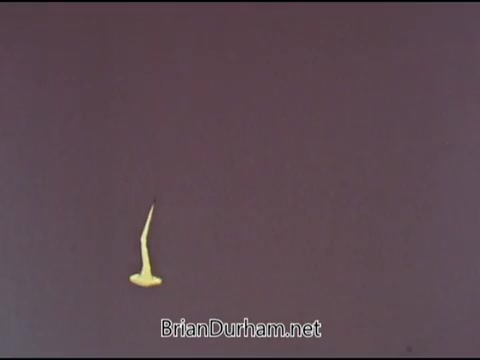 The still from the PSA 'American College of Surgeons - Tetanus/Lockjaw 1969' presents a simple visual, likely illustrating a yellow representation of a symptom or aspect related to tetanus. The background is a muted shade, possibly to draw attention to the yellow figure. The context emphasizes the importance of treating wounds properly, particularly puncture wounds, as they can harbor tetanus bacteria. The message underscores that even small injuries should be taken seriously to prevent serious health risks.