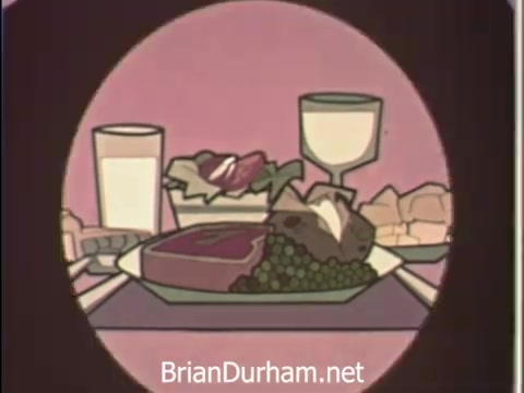 The still features a stylized food arrangement, showcasing a plate with a serving of meat, a green vegetable dish, and a small salad. There are also two beverages—one in a glass and another in a bowl. The background is a soft, muted color, emphasizing the food items. This visual likely aims to promote healthy eating as part of the American Medical Association's public service announcement from the late 1960s.