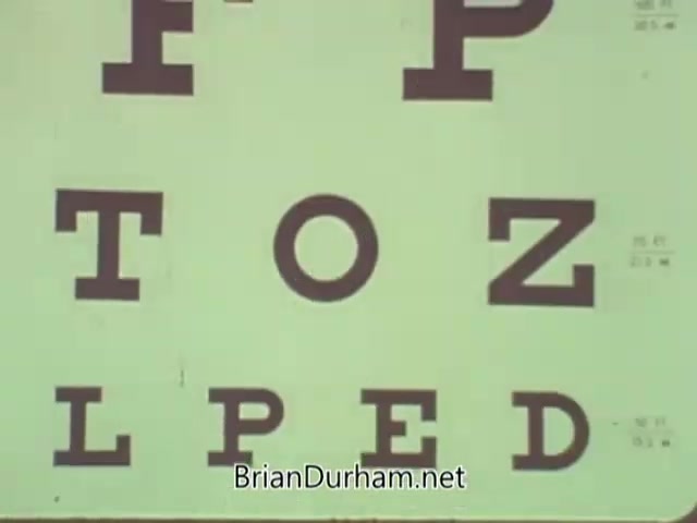 The still features a visual of an eye chart with large, bold letters arranged in a standard format used for vision tests. The letters include 'F,' 'P,' 'T,' 'O,' 'Z,' 'L,' 'P,' 'E,' and 'D.' This visual likely serves as part of a public service announcement by the American Optometric Association from the 1960s, emphasizing the importance of eye health and vision testing. The background is light, making the letters prominent.