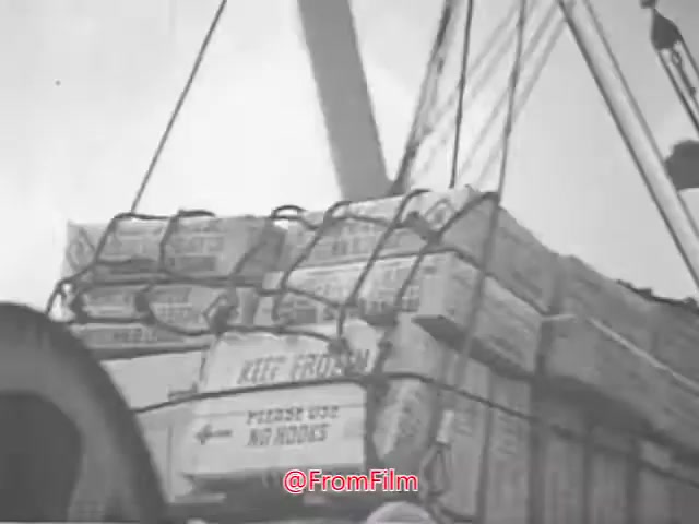 The still shows a cargo load being lifted on a ship, featuring stacks of boxes tied together. The boxes have visible labeling, including the instruction 'KEEP FROM' prominently displayed. The image appears to capture a moment related to shipping or transport, likely emphasizing the message or content of the Project CARE PSA from the 1960s. The monochrome aesthetic suggests a vintage presentation typical of that era.