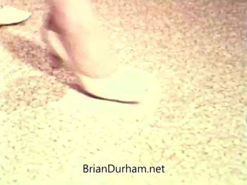 The 16mm still shows a close-up of a woman's foot in a pale shoe stepping on a carpeted surface. The image appears to emphasize foot placement and movement, likely in the context of promoting safety or awareness, aligning with the theme of the National Safety Council PSA. The overall tone suggests caution or focus on careful walking.