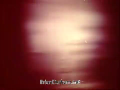 The 16mm still from the 'National Safety Council PSA' features a blurred, abstract composition with soft light emanating from a central source. The color palette leans toward warm tones, likely red and orange, creating a sense of urgency or concern. The visual style is reminiscent of vintage safety awareness campaigns, aiming to capture attention while conveying a critical message about safety.