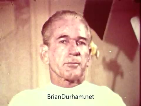 The still from the 'National Safety Council PSA' shows a middle-aged man with a serious expression, wearing a white shirt. The background is softly blurred, indicating a focus on him. The lighting is warm, and the overall tone suggests the seriousness of the safety message being conveyed in the PSA.