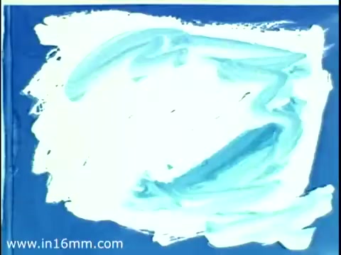 The still from the 1975 Christmas Seal PSA features a bold, abstract design with swirls of light blue and white against a blue background. The imagery reflects the creative and festive spirit associated with holiday campaigns, suggesting themes of generosity and support for health initiatives. Overall, it embodies a nostalgic representation of awareness around the Christmas Seal program.