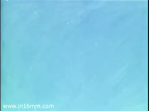 The still from the 1975 Christmas Seal PSA depicts a serene blue background, suggesting a calm, wintry atmosphere. The simplicity of the image emphasizes the message of holiday giving and charity associated with Christmas Seals. It conveys a nostalgic, peaceful moment, likely aimed at encouraging viewers to participate in the campaign.