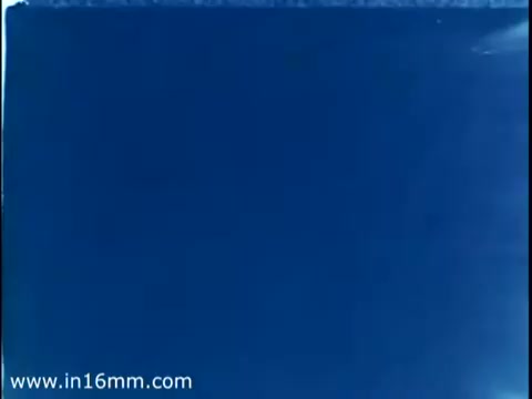 The still from the 1975 Christmas Seal PSA features a blue background, typical of promotional materials from that era. The focus is likely on raising awareness for the Christmas Seal campaign, which aimed to support tuberculosis research and prevention. Such seals are less commonly used today, although some may still reminisce about them, like a grandmother recalling past traditions.