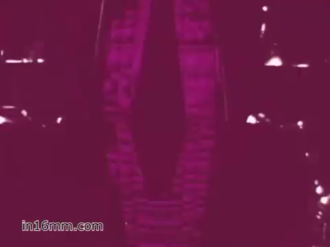 The still from the 16mm print of the 'West Virginia Safety Council PSA' showcases a vehicle undergoing inspection, emphasizing safety protocols from the 1960s. The image likely features tools or equipment used in the inspection process, framed with a color tone that gives it a vintage aesthetic, reflecting the era's public service messaging on vehicle safety.