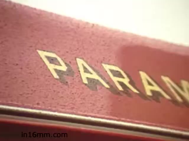 The still appears to show a close-up of the word 'PARAMOUNT' from a red surface, which may suggest it relates to a production or distribution company connected to film. Given the context of 'Walk Safely,' this could pertain to safety education or awareness, possibly disseminated through visual media typical of the 1980s. The film may aim to promote pedestrian safety and awareness among viewers.