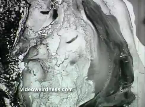 The still from the 1957 Kaiser Aluminum commercial presents an abstract, artistic imagery, likely meant to illustrate concepts related to freshness and preservation. The visual texture appears fluid and dynamic, potentially symbolizing the protective qualities of aluminum foil in keeping bread fresh. The aesthetic reflects the mid-century style, focusing on innovative materials and their benefits in everyday life.