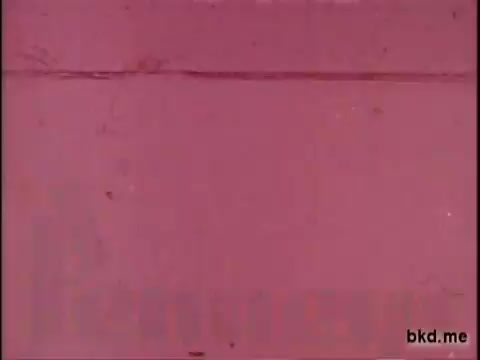 The still from the 16mm print of the J.C. Penney commercial features a predominantly pink background. The image appears aged, with some wear and scratches typical of vintage film. There are no distinct visual elements or characters present, focusing instead on the color and texture of the film.