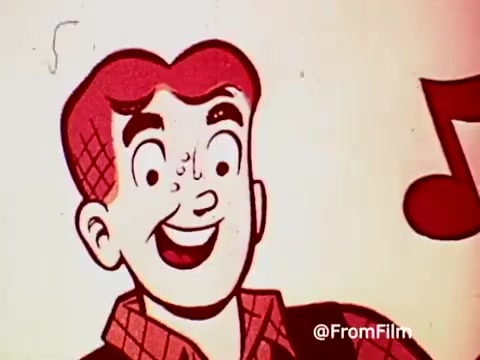 The still features a cheerful, cartoonish character with red hair and a smile, likely representing Archie from the Archie Comics. He appears in a colorful, playful style typical of 1960s animation. A musical note is shown, enhancing the upbeat vibe of the scene, promoting the connection between the character and Post Alpha Bits cereal. The overall aesthetic is vibrant and nostalgic, reflecting the advertising style of that era.