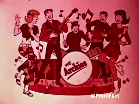 The still features a colorful cartoon illustration of 'The Archies,' a fictional band from the 1960s. The group is depicted in a lively scene, with four members playing instruments and two characters dancing. Musical notes fill the background, enhancing the energetic vibe. The overall aesthetic is vibrant and playful, typical of the era's animation style, serving as a promotional piece for Post Alpha Bits cereal.