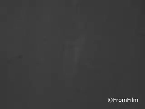 The still from the 'Radio Free Europe PSA - Bob Hope - 1969' features a vintage aesthetic typical of mid-20th century film. It likely showcases a segment where comedian Bob Hope discusses the importance of free information and expression. This public service announcement aims to raise awareness about the role of Radio Free Europe in providing news and analysis to countries under authoritarian regimes, emphasizing the value of a free press. The visual style may include graininess characteristic of 16mm film, underscoring the historical context of the period.