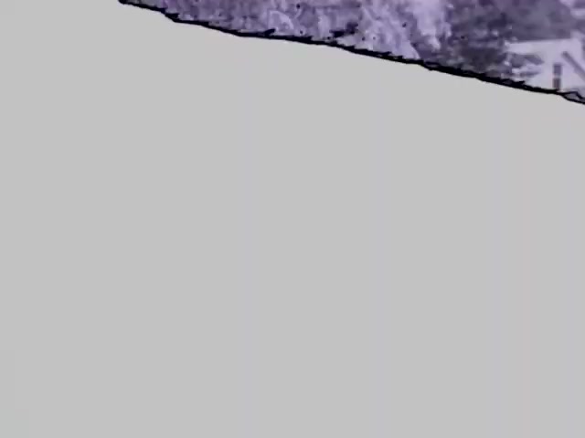 The 16mm still from 'Pat in Ocean - 1955' features a black-and-white image that likely captures a moment on the beach or near the ocean. The scene may include elements like waves, shoreline, or coastal vegetation, characteristic of the 1950s. The image's composition and lighting evoke a nostalgic, vintage aesthetic typical of that era's film.