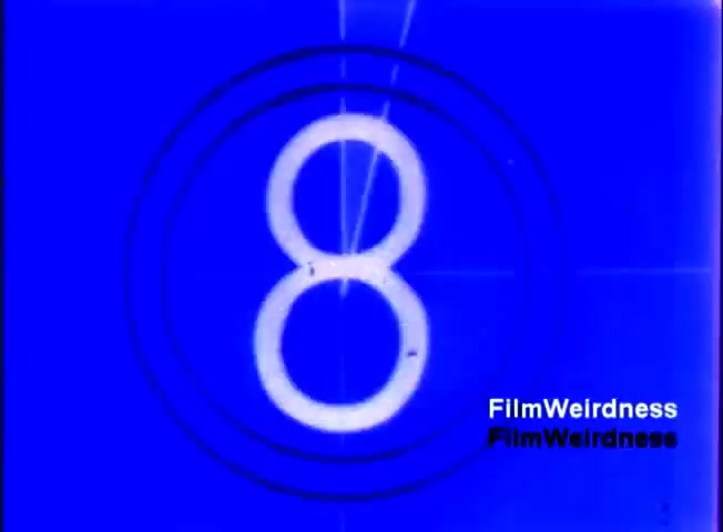 The still features a blue background with a white circular countdown marker displaying the number '8'. This is indicative of a countdown timer commonly used in film editing and projection. The visual is characteristic of early 1980s film technology, likely signaling the start of a segment related to the IBM System 36 sales film from 1984. The watermark 'FilmWeirdness' is visible in the corner.