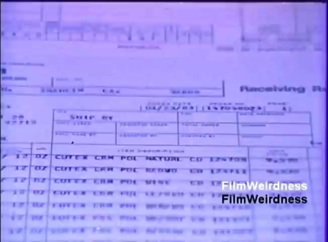 The still features a close-up of a printed document, likely a form used for data processing or inventory management. The text is presented in a tabular format, displaying various fields and entries related to items or transactions. The colors appear faded, with a bluish tint, typical of older film stock. The context suggests this is part of a sales film promoting the IBM System 36, emphasizing the system's capabilities in handling business forms and data management.