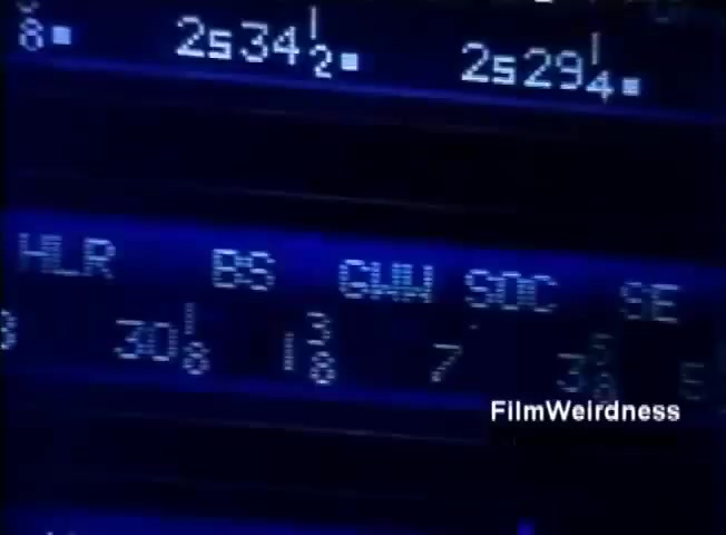 The still features a close-up view of a digital display panel, likely from the IBM System 36. It shows various alphanumeric codes and values, with a blue backlighting that provides a technical, retro aesthetic. The screen includes references to metrics or system statuses, indicating its purpose in monitoring or managing operations.