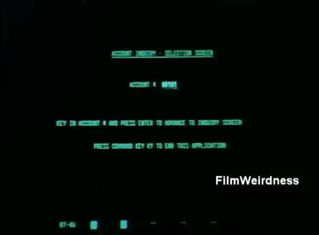 The still from the 'IBM System 36 sales film 1984 - part 1' shows a computer screen with green text on a black background. The text indicates a user interface or command prompt, likely for accessing a database or application. Instructions include how to input a command, with a specific key to exit the application. The overall aesthetic reflects the technology of the 1980s, emphasizing the simplicity and functionality of early computer systems.