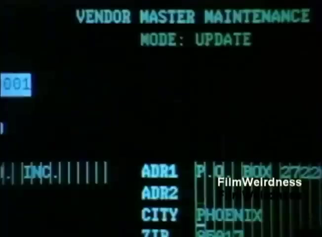 The still displays a computer screen interface from the IBM System 36 focused on 'Vendor Master Maintenance' in 'UPDATE' mode. It features text fields for information entry, including vendor identification numbers, address lines, city, and ZIP code, all presented in a simple green-on-black format typical of the era. The aesthetic reflects early computer technology used for business data management in the 1980s.