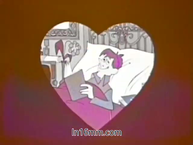 The still features an animated character, a young girl, lying in bed with a book. She has a playful expression and is dressed in cozy pajamas. The scene is framed within a heart shape, set against a warm, orange background. The overall tone is cheerful and lighthearted, typical of a public service announcement aimed at children about health awareness, likely regarding flu prevention.