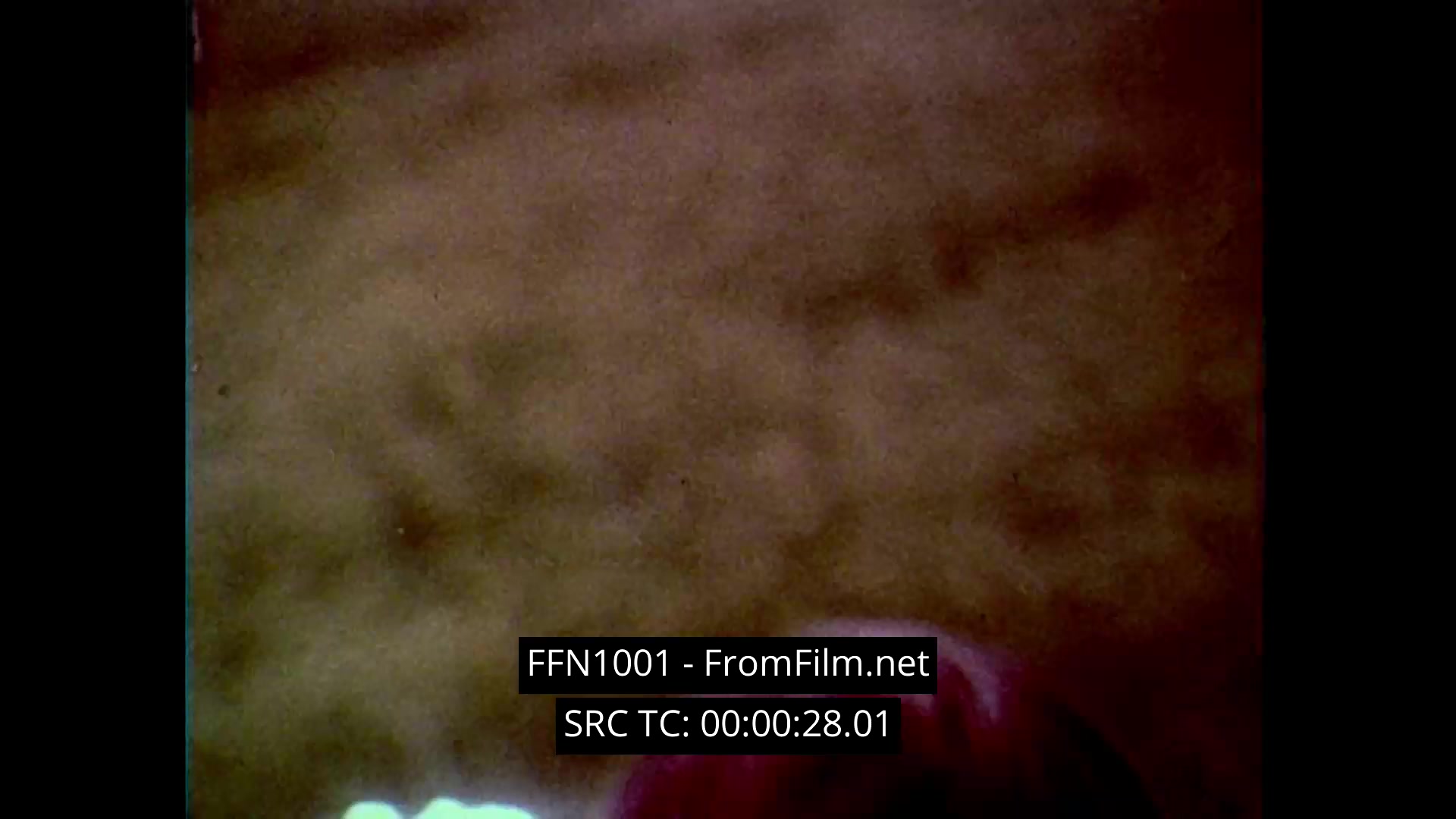 This 16mm still from Chanel No. 5: 'Tomorrow’s Woman' showcases a dreamy Chanel No. 5 advertisement, characterized by the soft-focus, ethereal aesthetics typical of the 1970s. The shot features close-ups of the iconic bottle against a blurred, warm background, enhancing the luxurious and intimate feel associated with the fragrance.